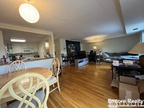 A dining room with a wooden table and chairs.