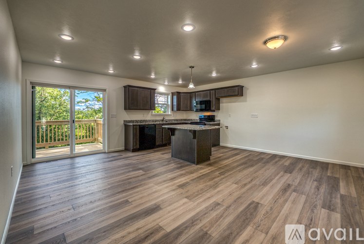 A kitchen with wooden floors and a large island in the middle.