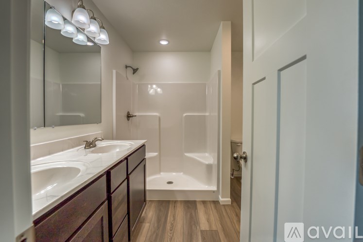 A bathroom with a white sink and a white tub.