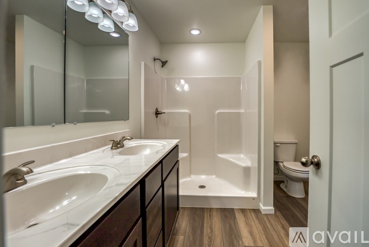 A bathroom with a white sink and a white tub.