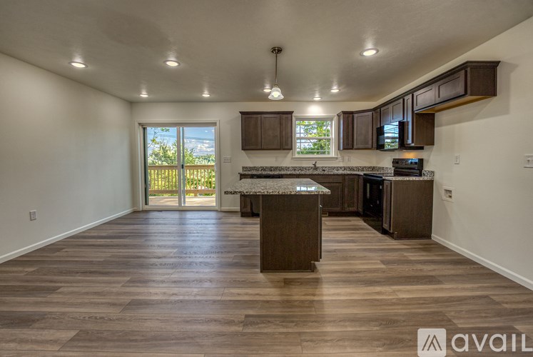 A kitchen with wooden floors and a large island in the middle.