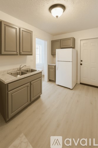 A kitchen with wooden cabinets and a white refrigerator.