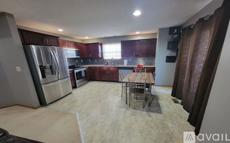 A kitchen with a table and chairs in the middle of the room.