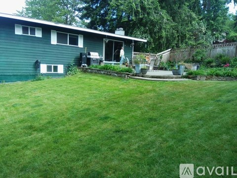 A house with a green lawn in front.