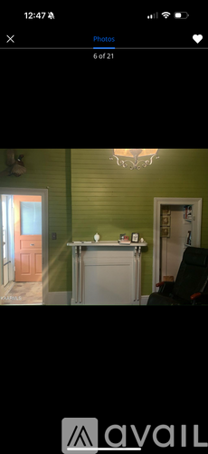 A room with green walls and a white door.