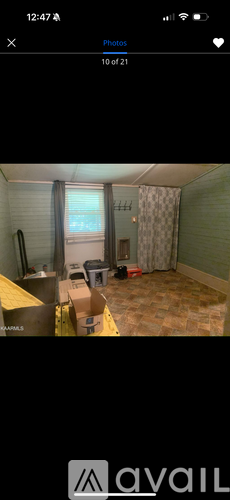 A room with a bed, a chair, and a window.