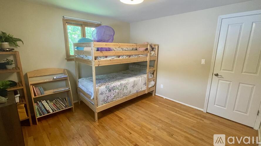 A bedroom with a bunk bed and a bookcase.