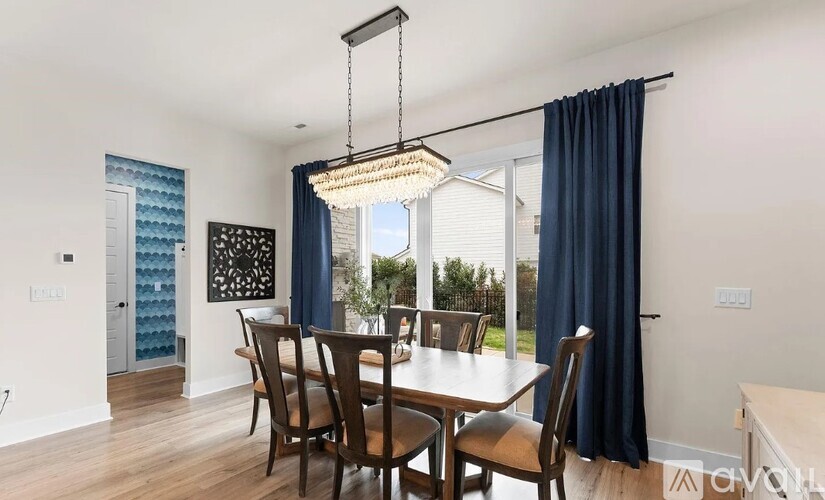 A dining room with a table and chairs.