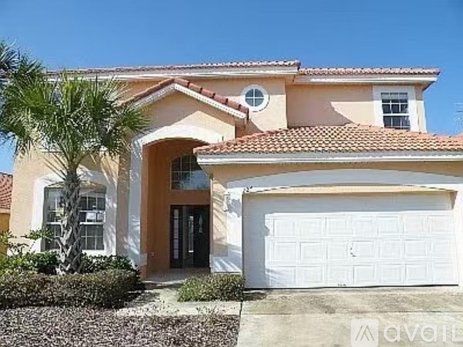 A house with a white garage door and a brown roof.