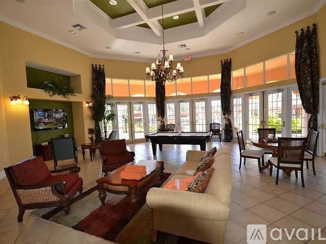 A living room with a large couch, chairs, and a TV.