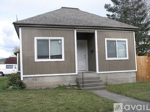 A small house with a brown and beige exterior is available for rent.