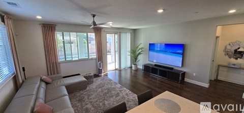 A living room with a television and a couch.