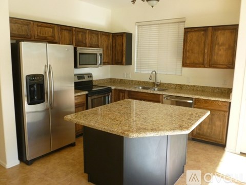 A kitchen with a granite counter top and stainless steel appliances.