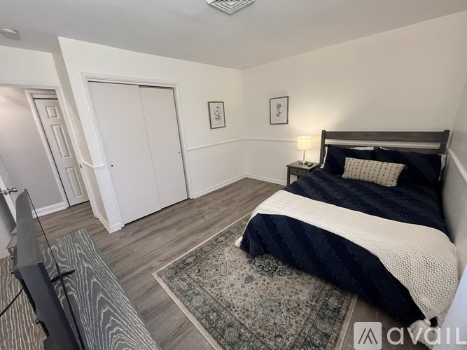 A bedroom with a large bed and a television.