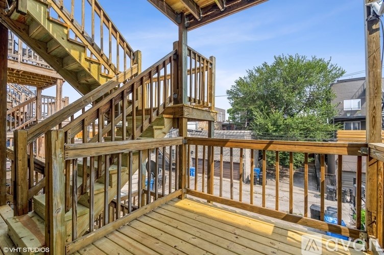 A wooden staircase with a railing is in the foreground of the image.