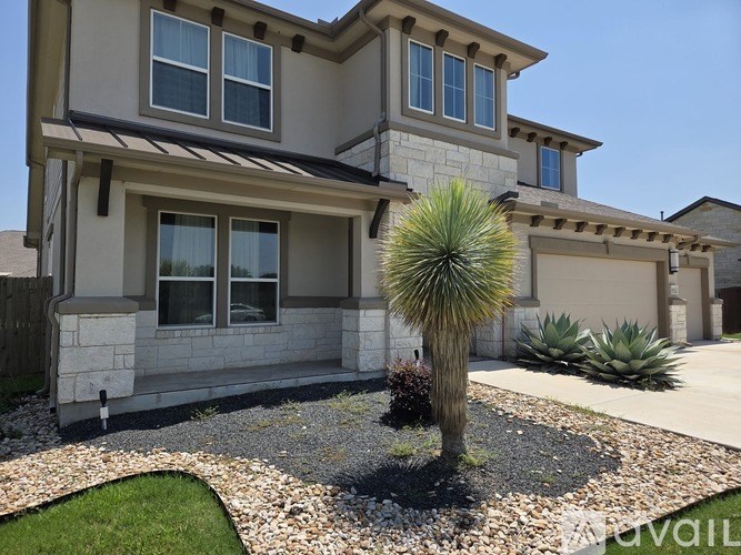 A house with a palm tree in front.