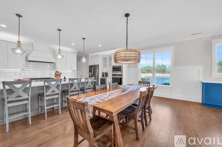 A modern kitchen with a dining table and chairs.
