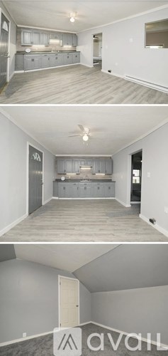 A modern living room with a grey sofa and a wooden floor.