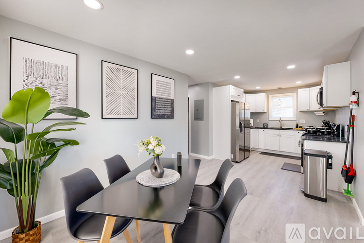 A modern kitchen with a dining table and chairs.