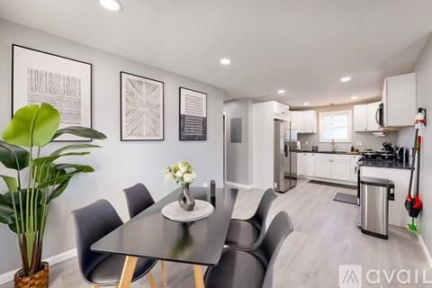 A modern kitchen with a dining table and chairs.