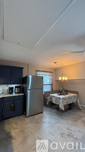 A kitchen with a table and chairs in the middle of the room.