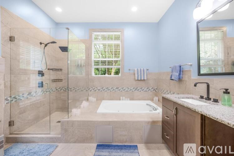 A bathroom with a walk-in shower, a bathtub, and a sink.