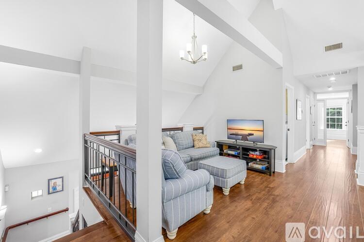 A living room with a blue couch and a television.