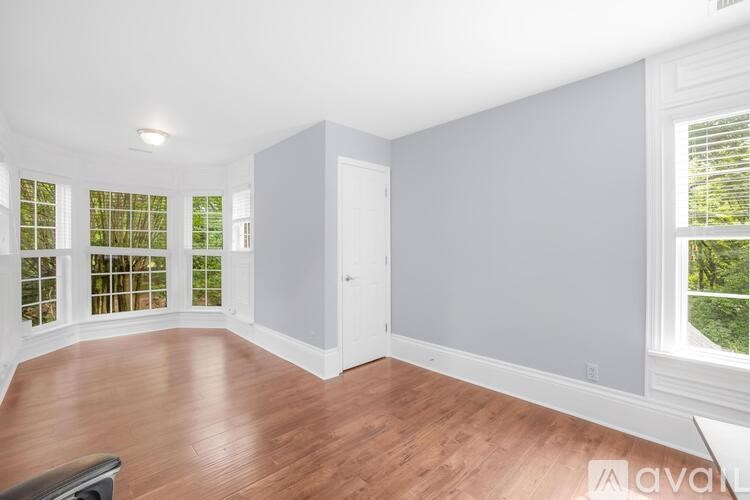 A room with wooden floors and white walls.