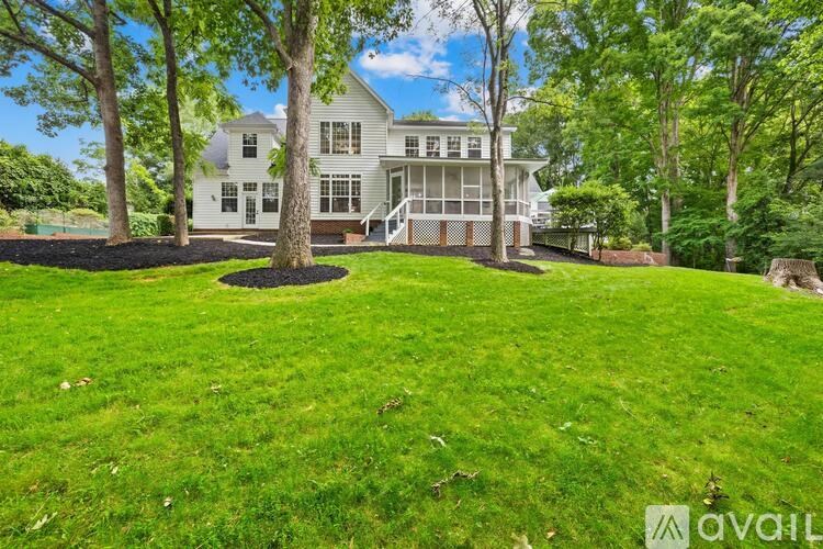 A large white house with a tree in front of it.