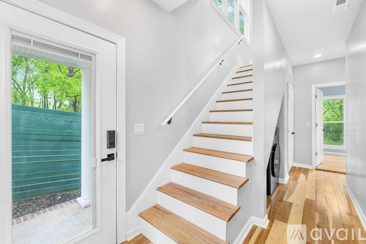 A staircase with wooden steps and white walls.