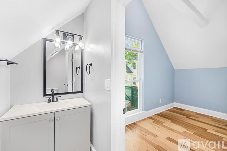 A bathroom with a white sink and a mirror above it.
