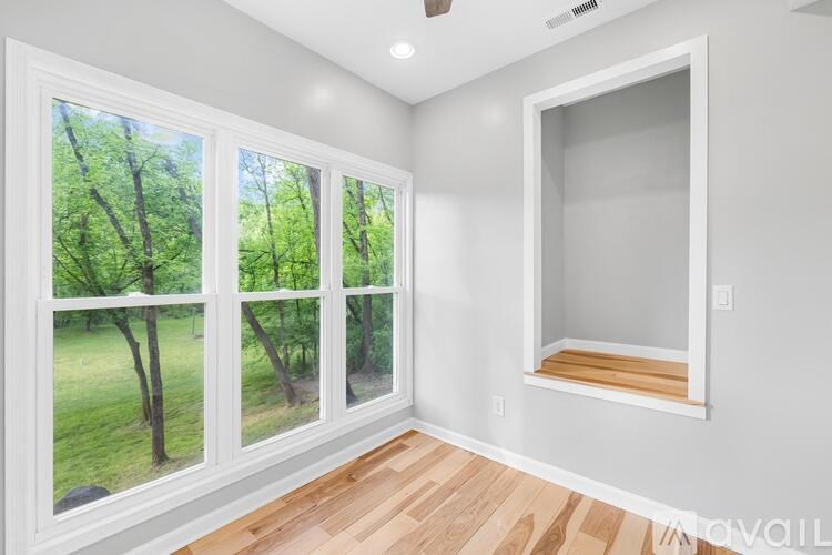 A room with a window showing trees outside.
