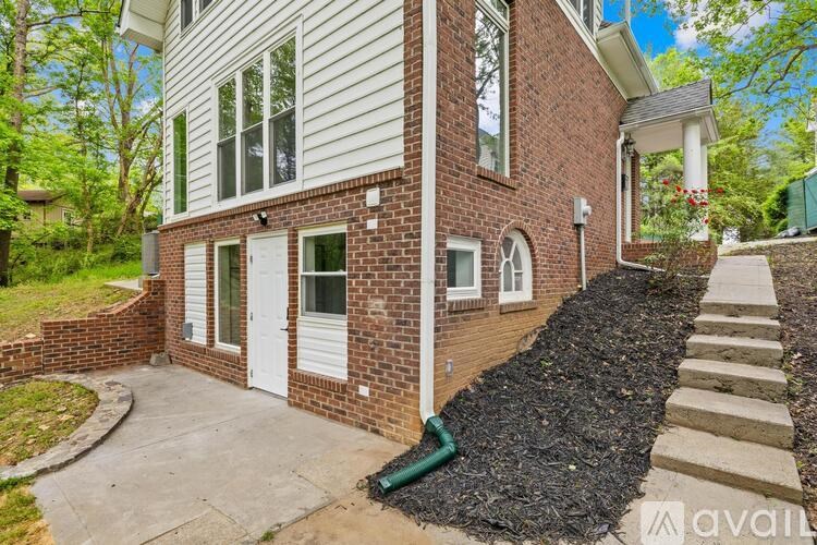 A house with a white siding and a brick chimney.