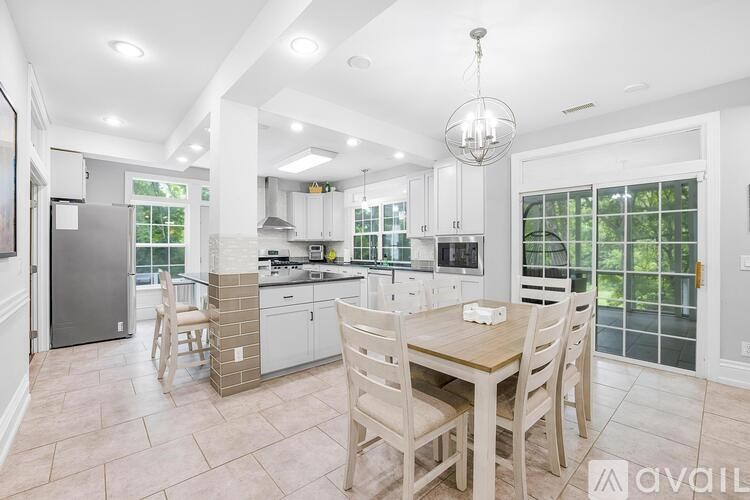 A kitchen with a table and chairs in the middle of the room.