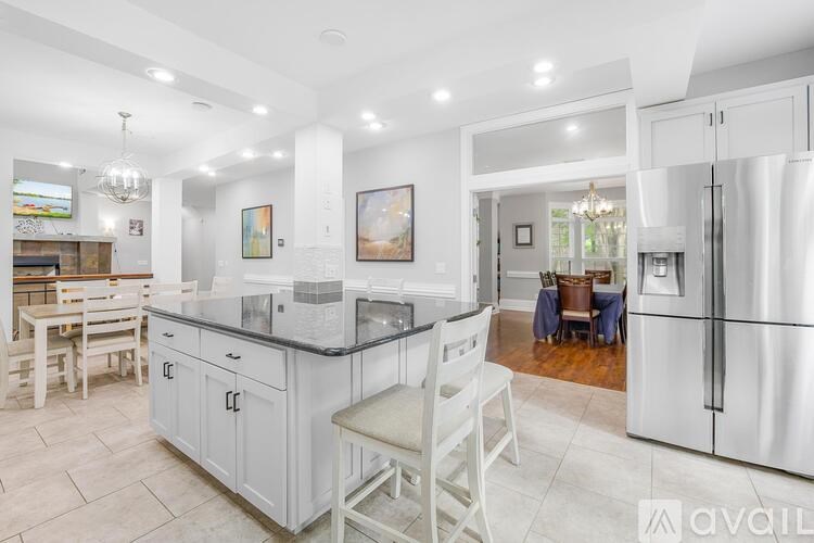 A modern kitchen with a large island and stainless steel appliances.