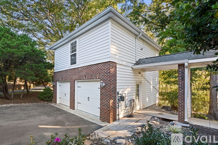 A house with a white garage door and a brick chimney.