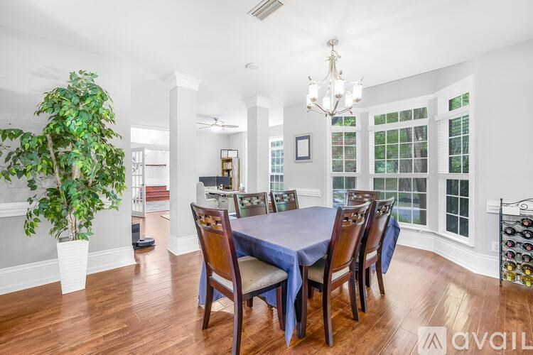 A dining room with a table set for six.
