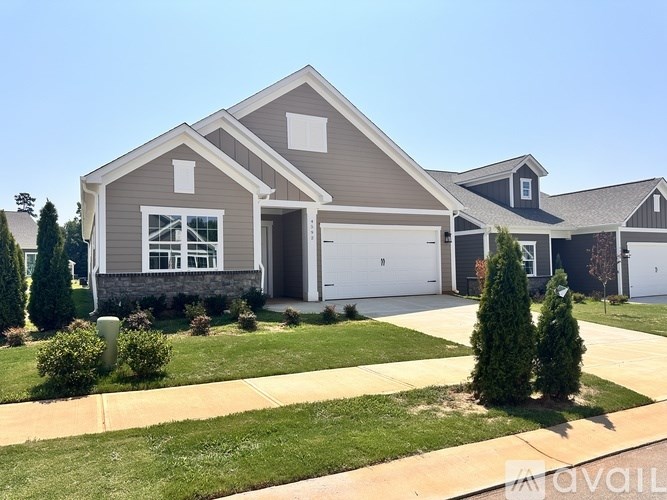 A house with a garage and a driveway in front.