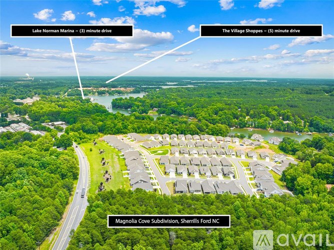 An aerial view of a subdivision with a road and houses.