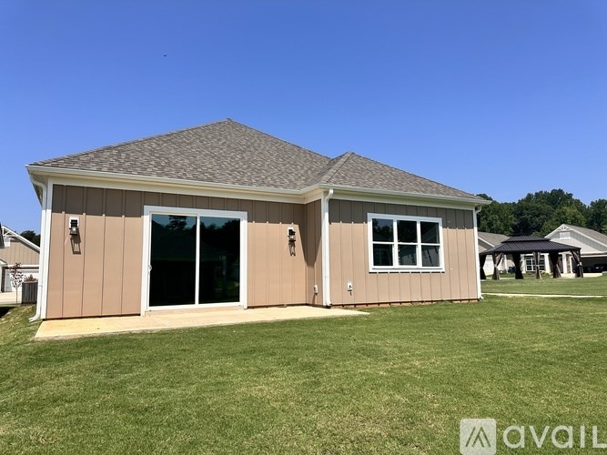 A house with a brown exterior and a grey roof is available for purchase.