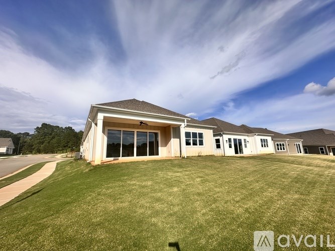 A house with a lawn in front and a sign that says "AVAILABLE".