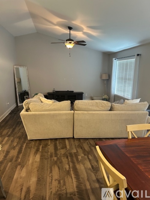 A living room with a piano and a couch.