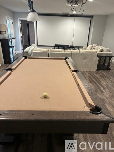 A pool table with a green ball in the middle of it.