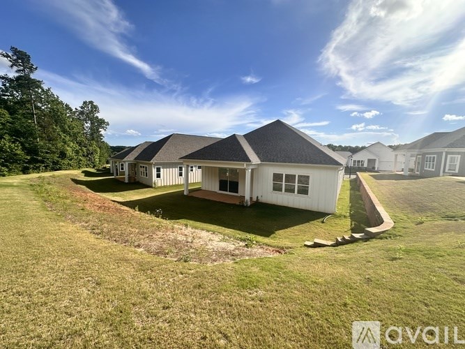 A house with a large front yard is for sale.