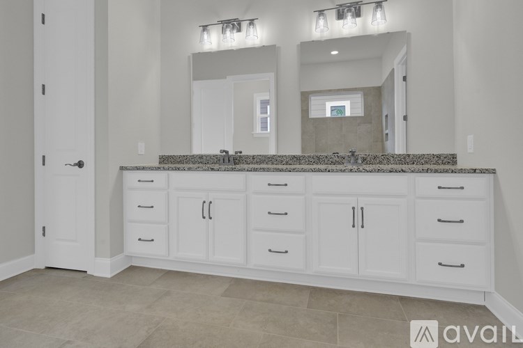 A bathroom with a vanity and a large mirror.