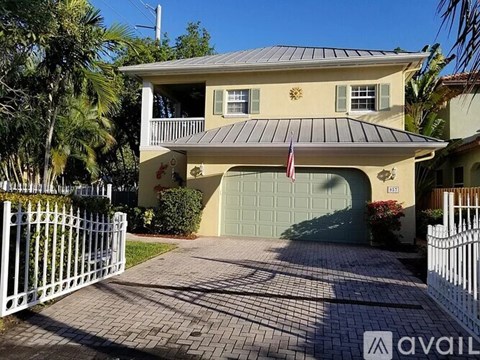 A two-story house with a garage and a flag on the front.