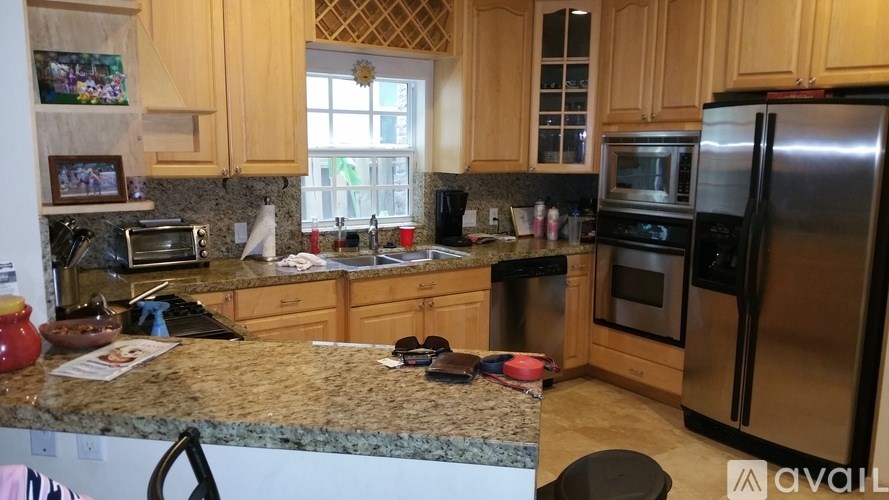 A kitchen with granite countertops and stainless steel appliances.