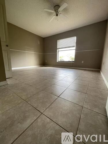 A room with tiled flooring and a ceiling fan.