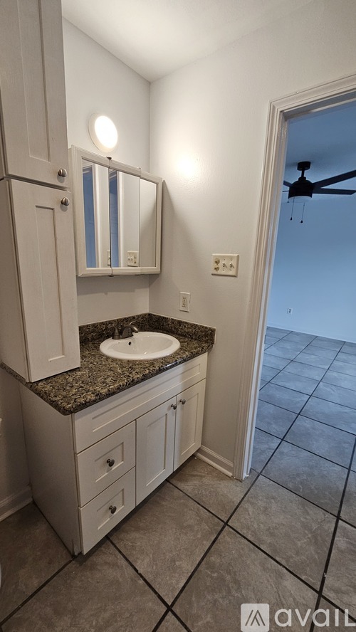 A bathroom with a sink and a mirror.