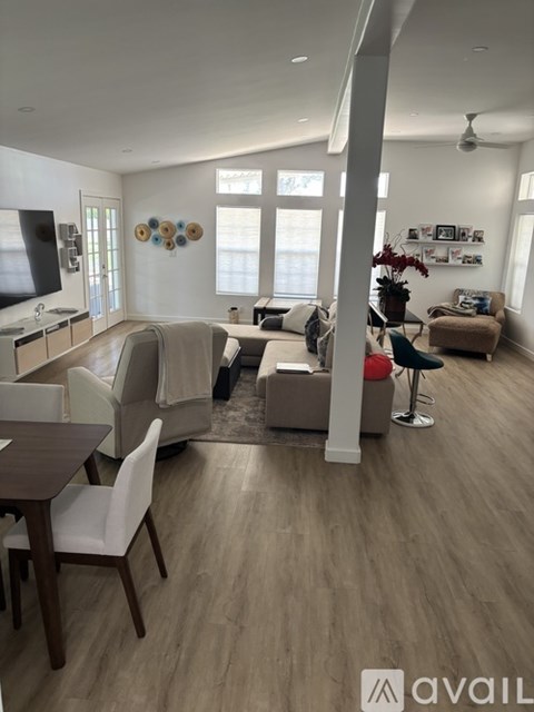 A living room with a dining table and chairs.